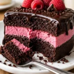 dark chocolate raspberry mousse cake with rich layers and fresh raspberries on a plate