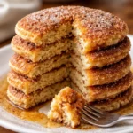 stack of irresistible Spanish churro pancakes with cinnamon sugar on a plate